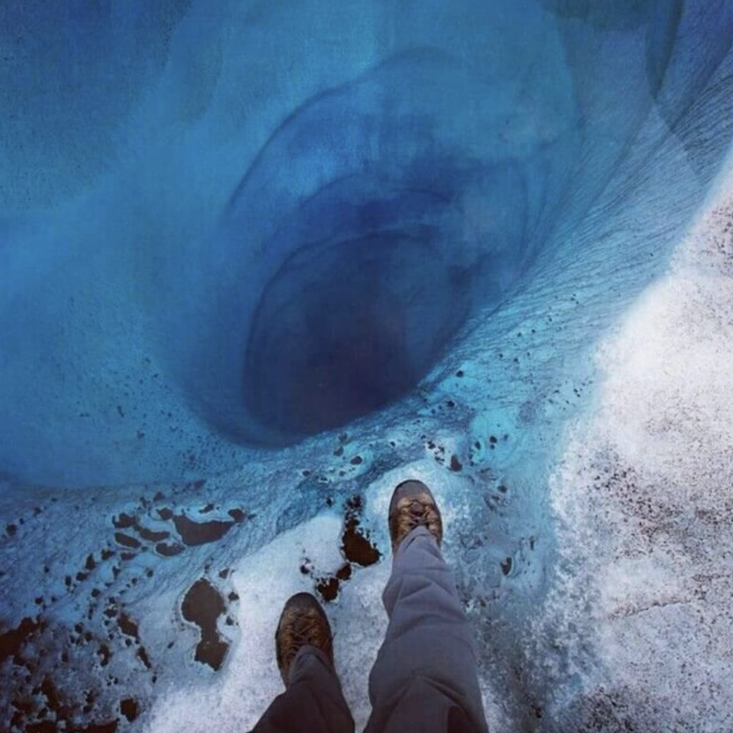 feet at the edge of a very deep hole