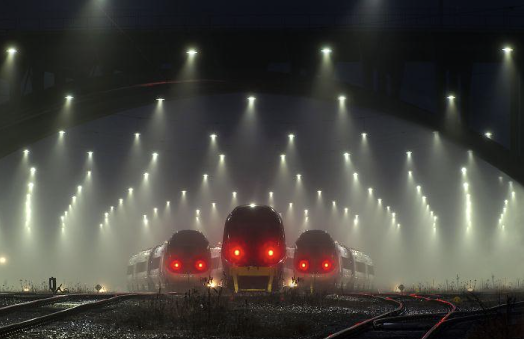 three trains with red eyes in the dark so they look angry