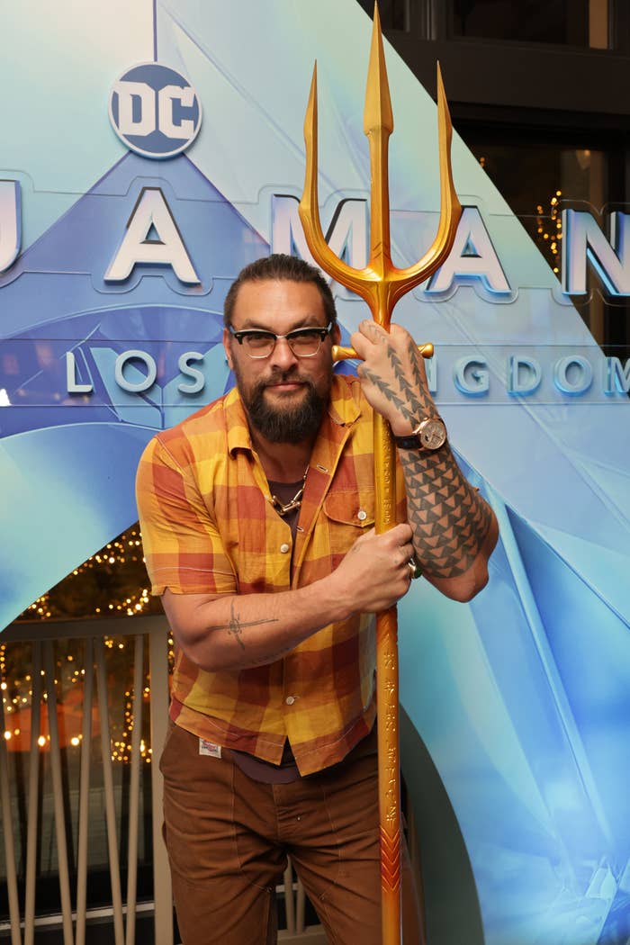 Jason posing with a trident for a movie premiere