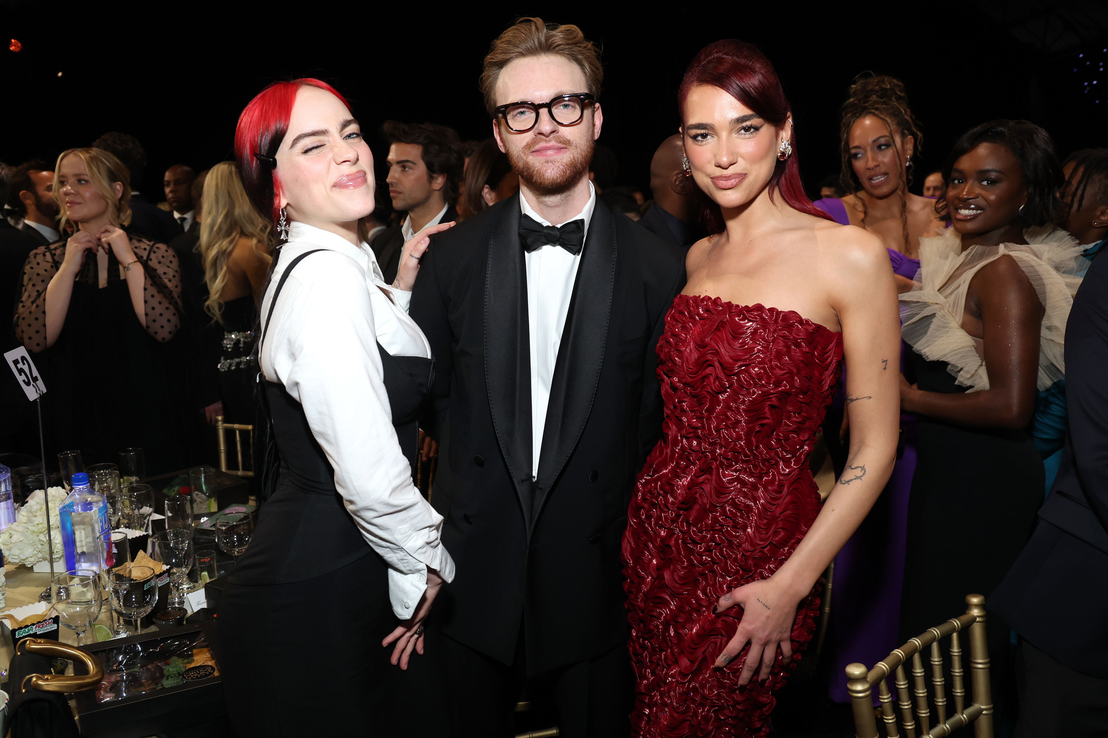Billie Eilish, Finneas, and Dua Lipa pose for a photo at the awards show