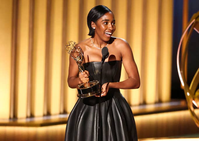 Ayo Edebiri holding her Emmy onstage
