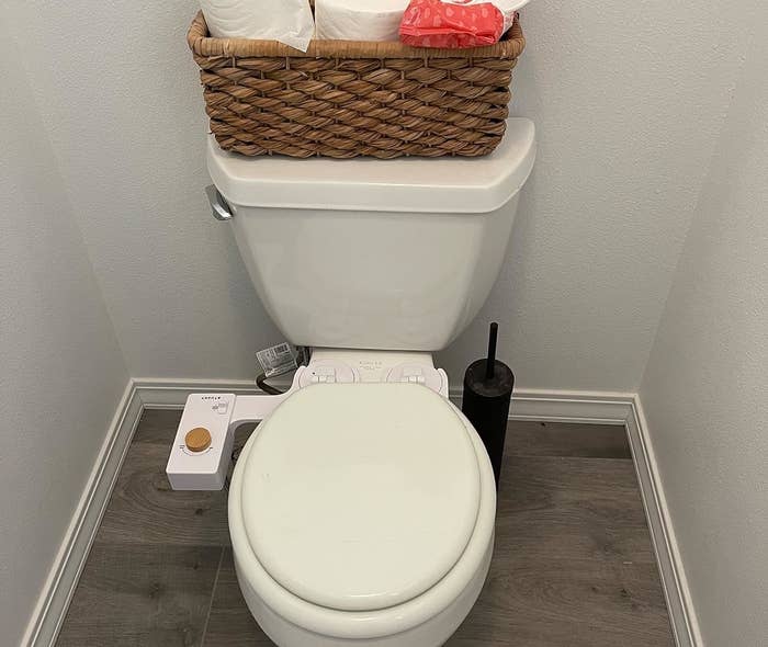 The white bidet attached to a reviewer&#x27;s toilet