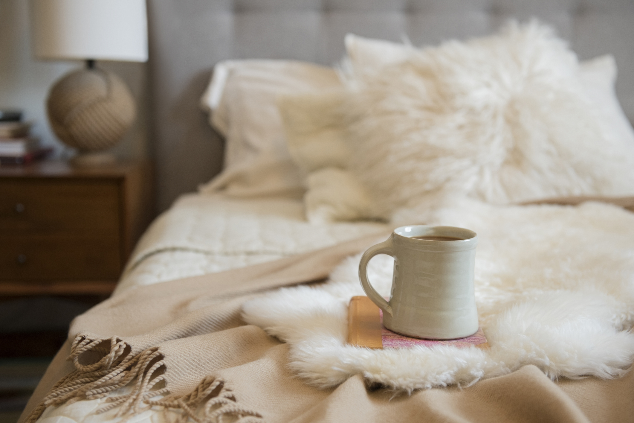coffee mug on a bed