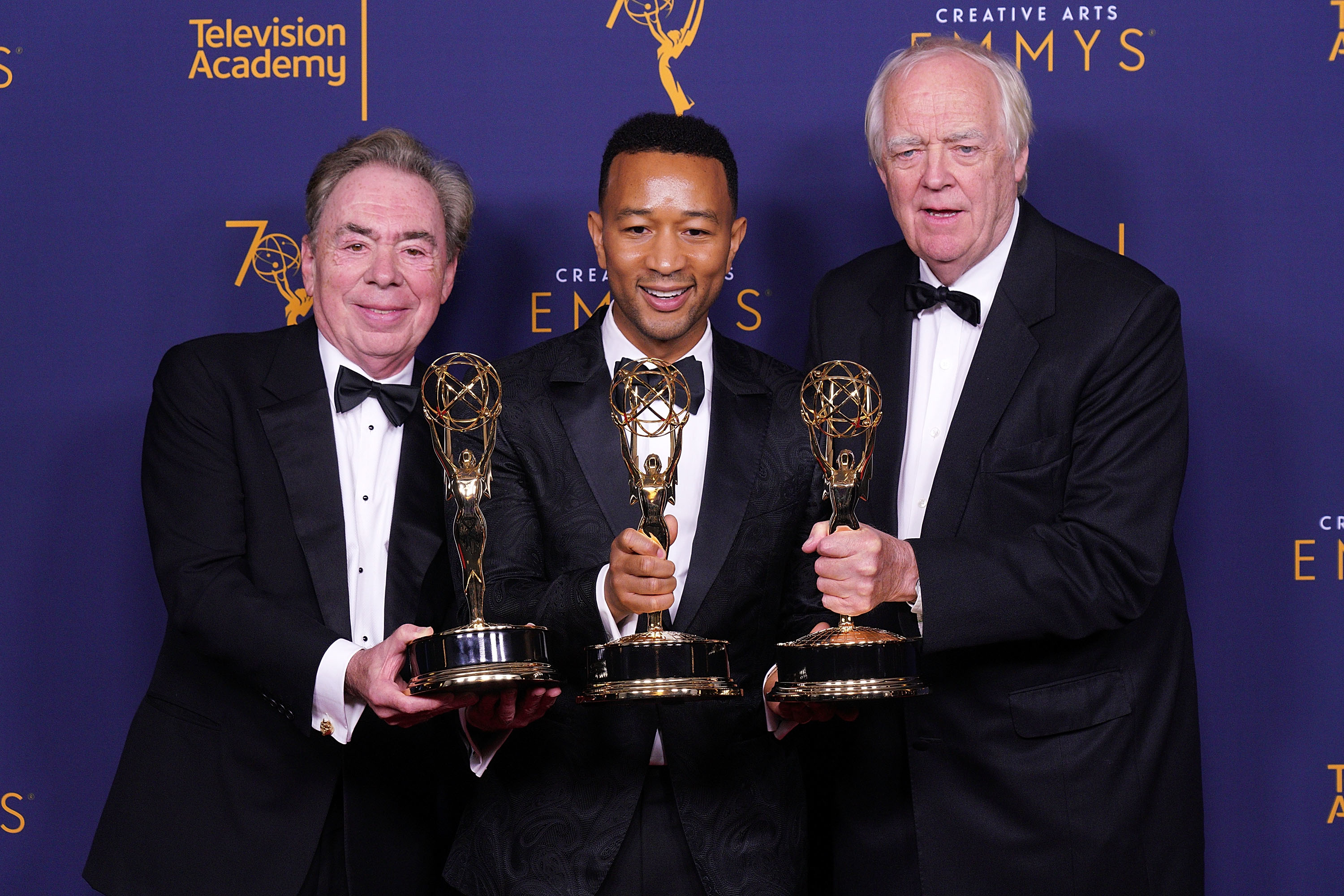 Andrew Lloyd Webber, John Legend and Tim Rice holding their Emmys