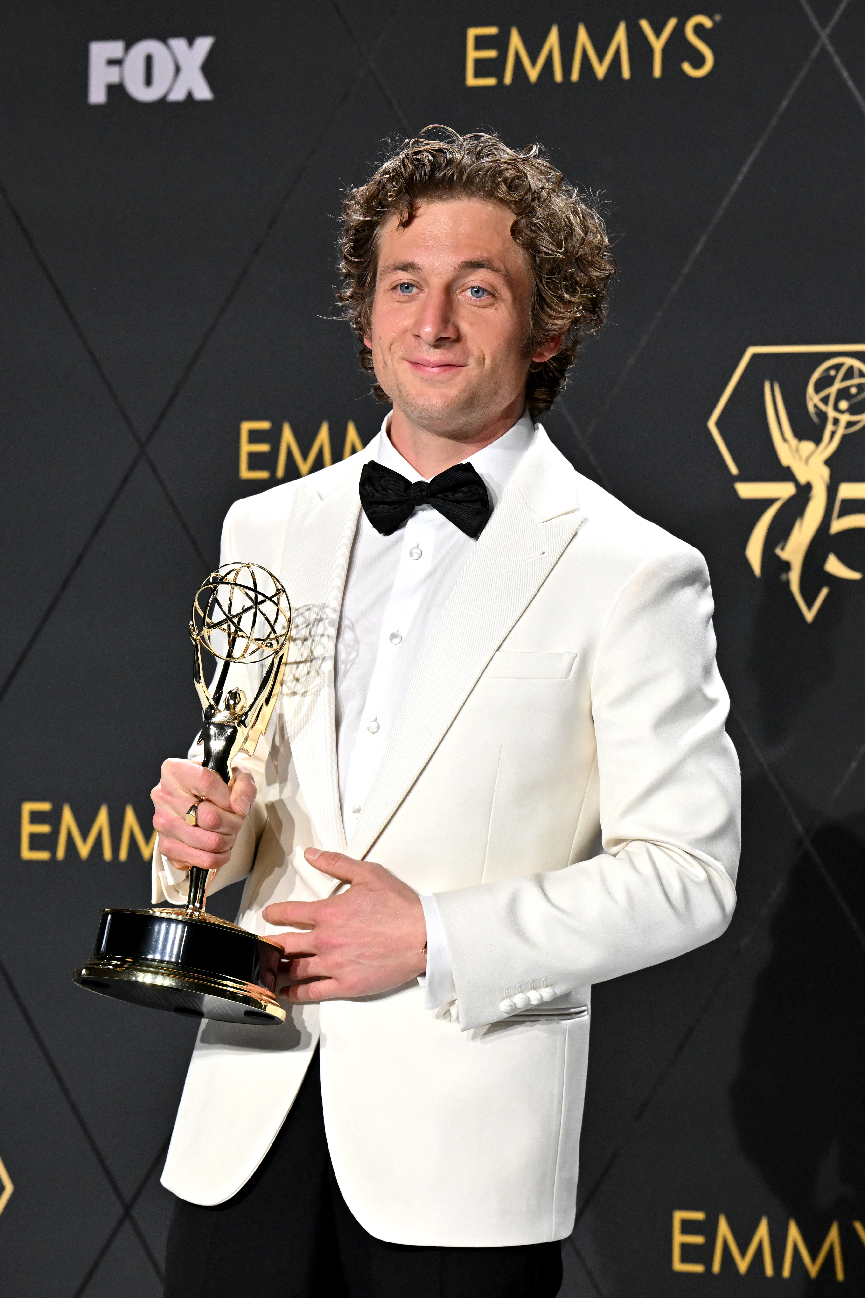 Jeremy Allen White holding his Emmy