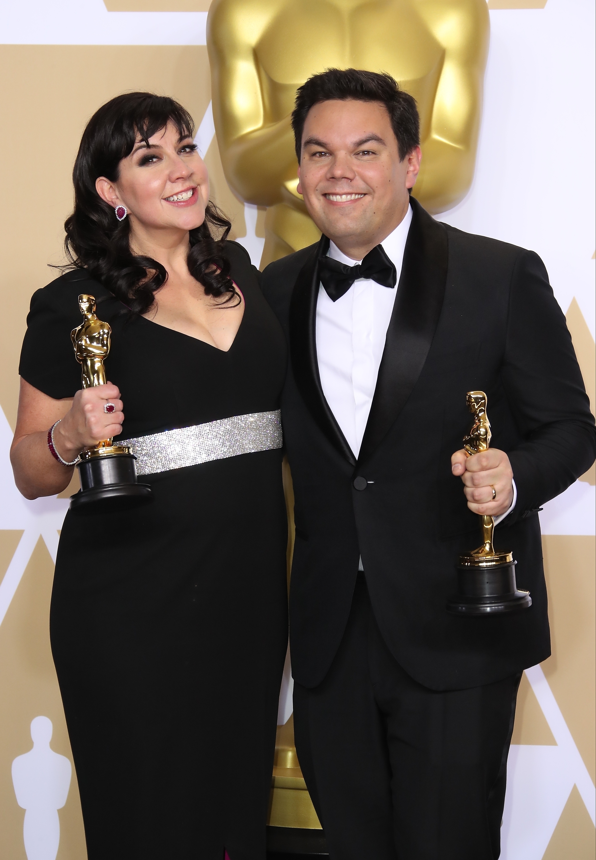 Robert Lopez and his partner with their Oscars