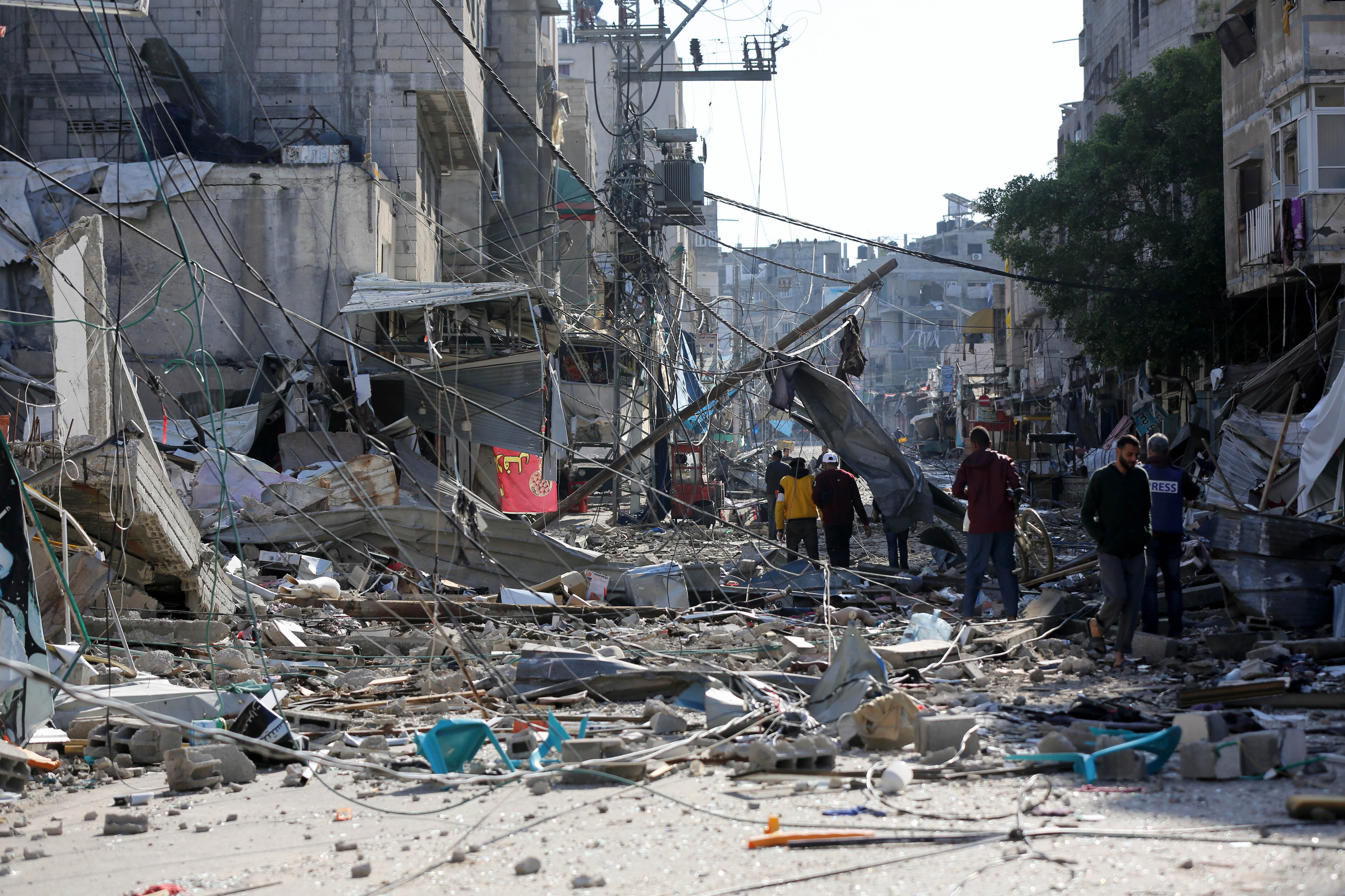 bombed city left in ruin as people try to walk the streets