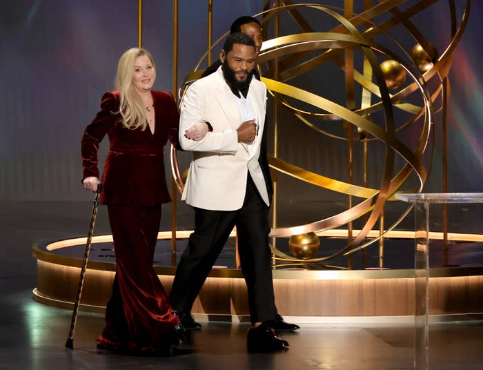 Anthony Anderson escorting Christina Applegate onstage at the Emmys