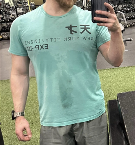 Closeup of a guy sweating through his shirt