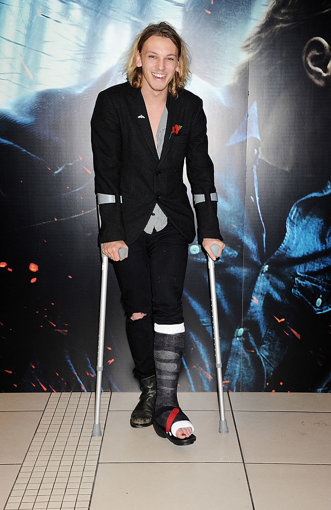 Jamie Campbell Bower with crutches