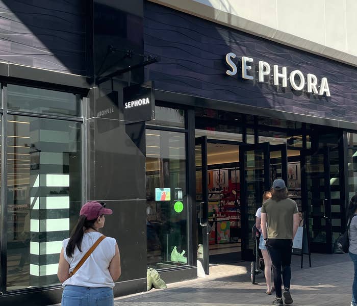 shoppers walking into a sephora store in a mall