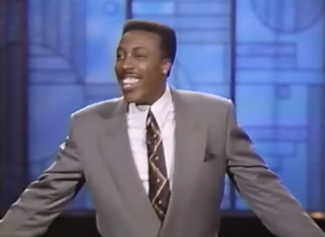 arsenio hosting in front of a large geometric screen