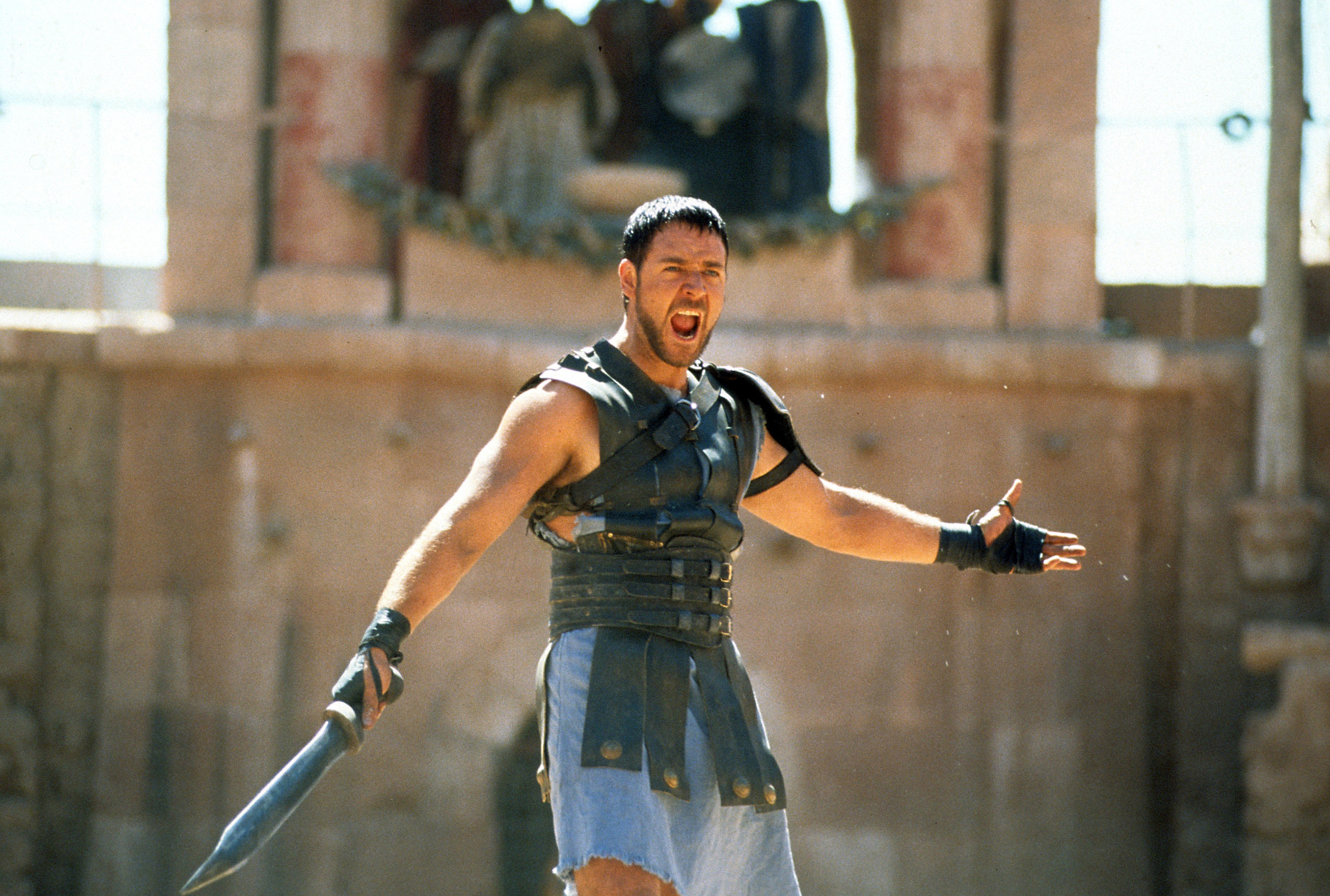 Russel Crowe yielding a sword in a scene from Gladiator