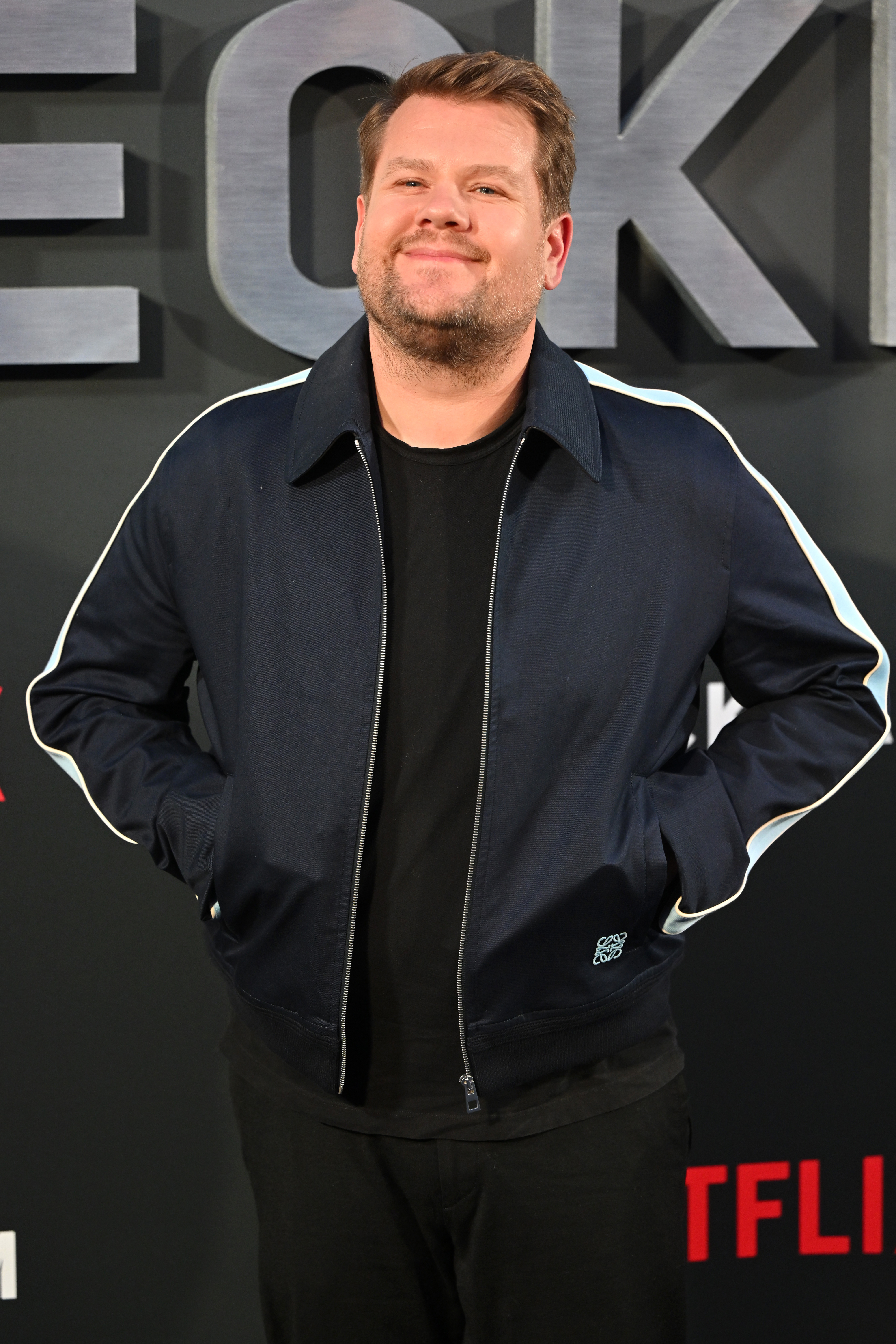 Close-up of James in a casual jacket at a media event