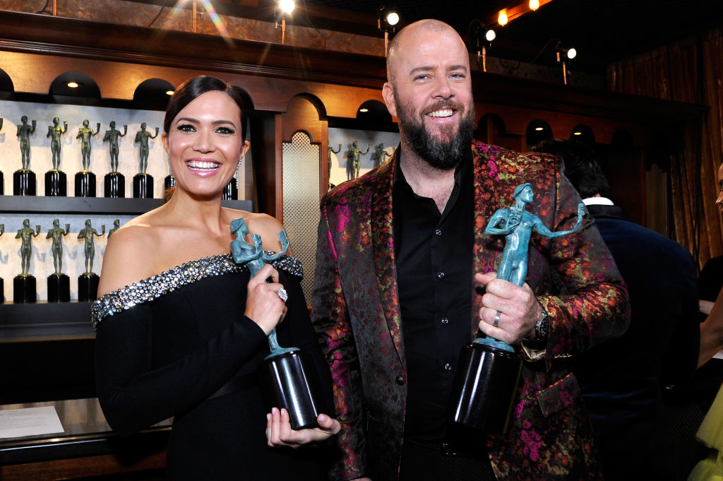 Mandy Moore and Chris Sullivan holding awards