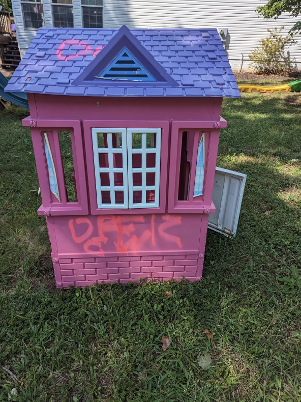 A playhouse with graffiti on it