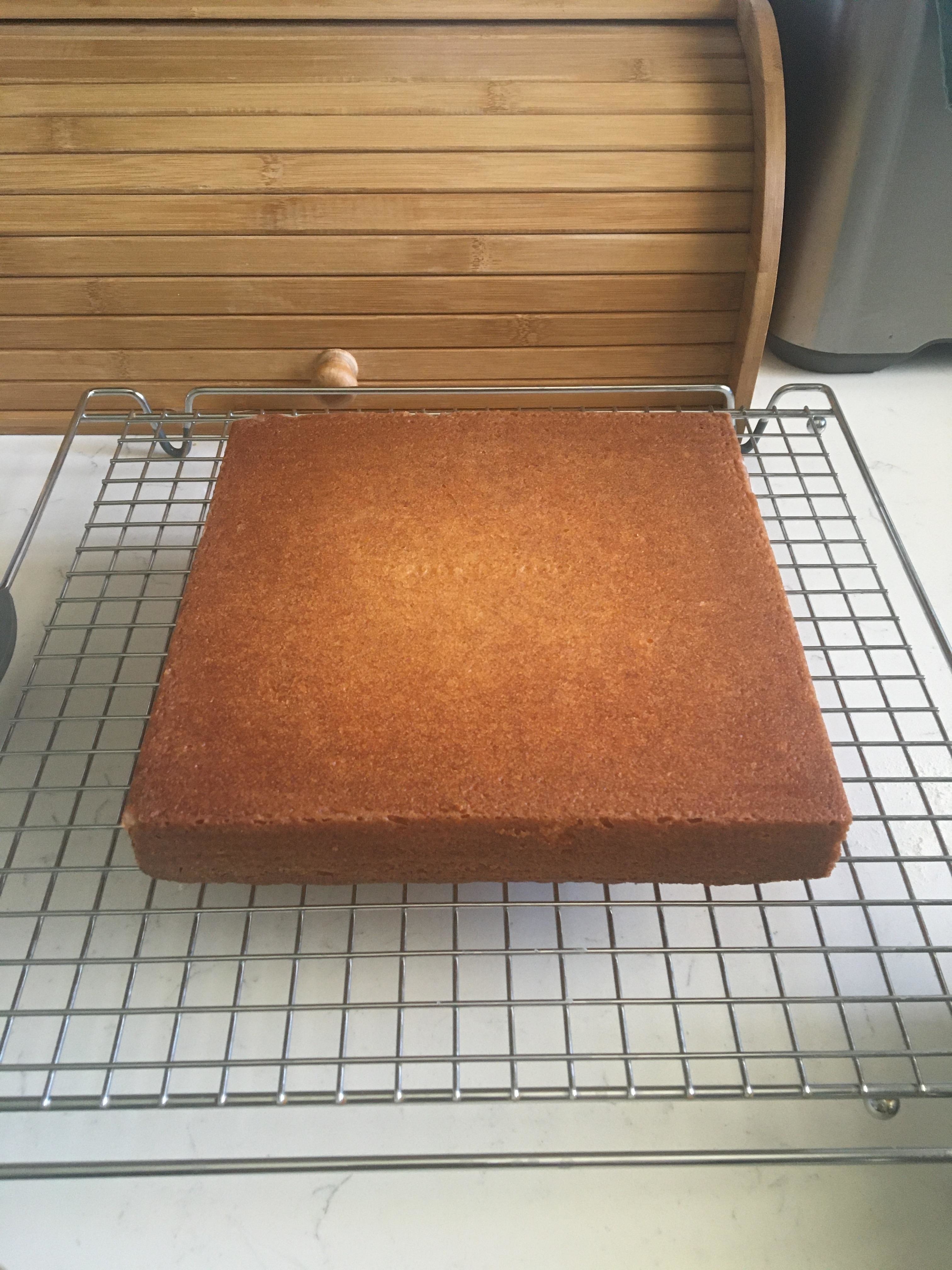 A square cake on a cooling rack