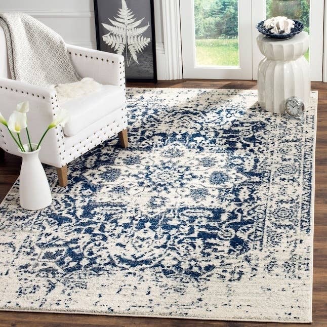 the blue and white patterned rug in a room