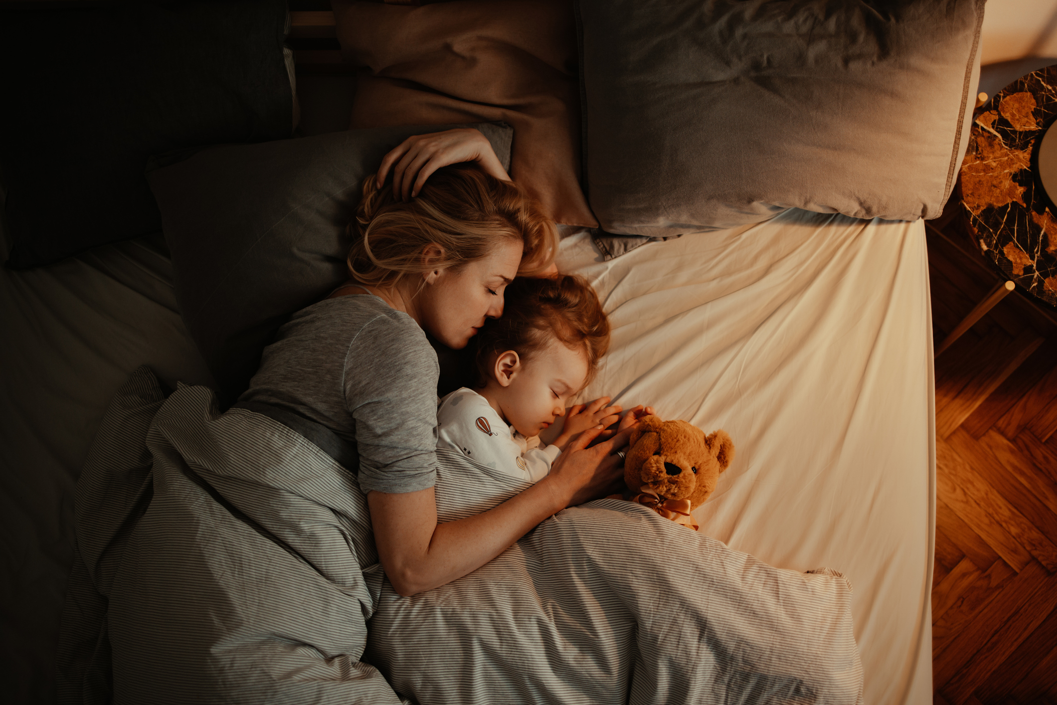A mother and child cuddling in bed