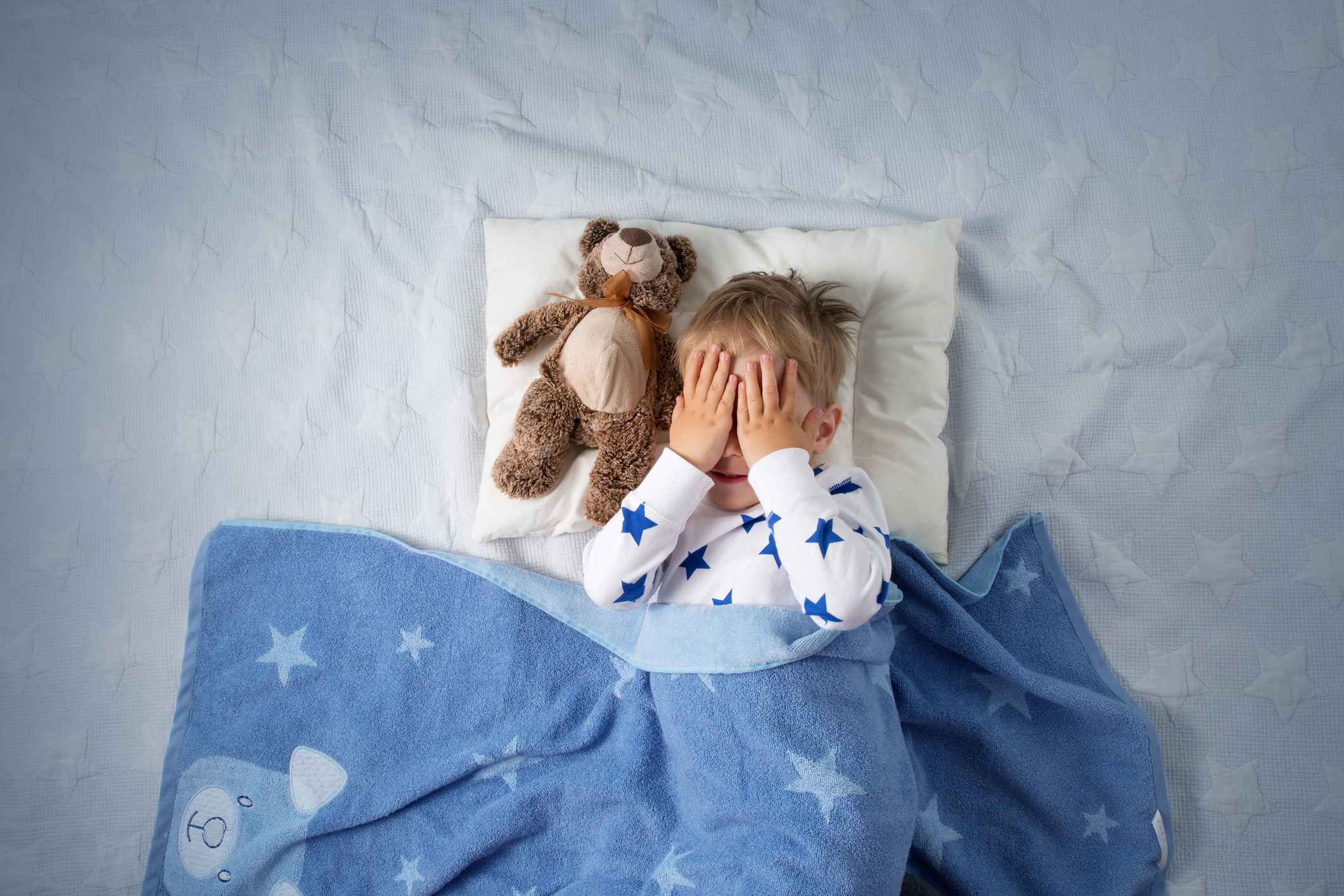 Little boy sleeping with stuffed animal