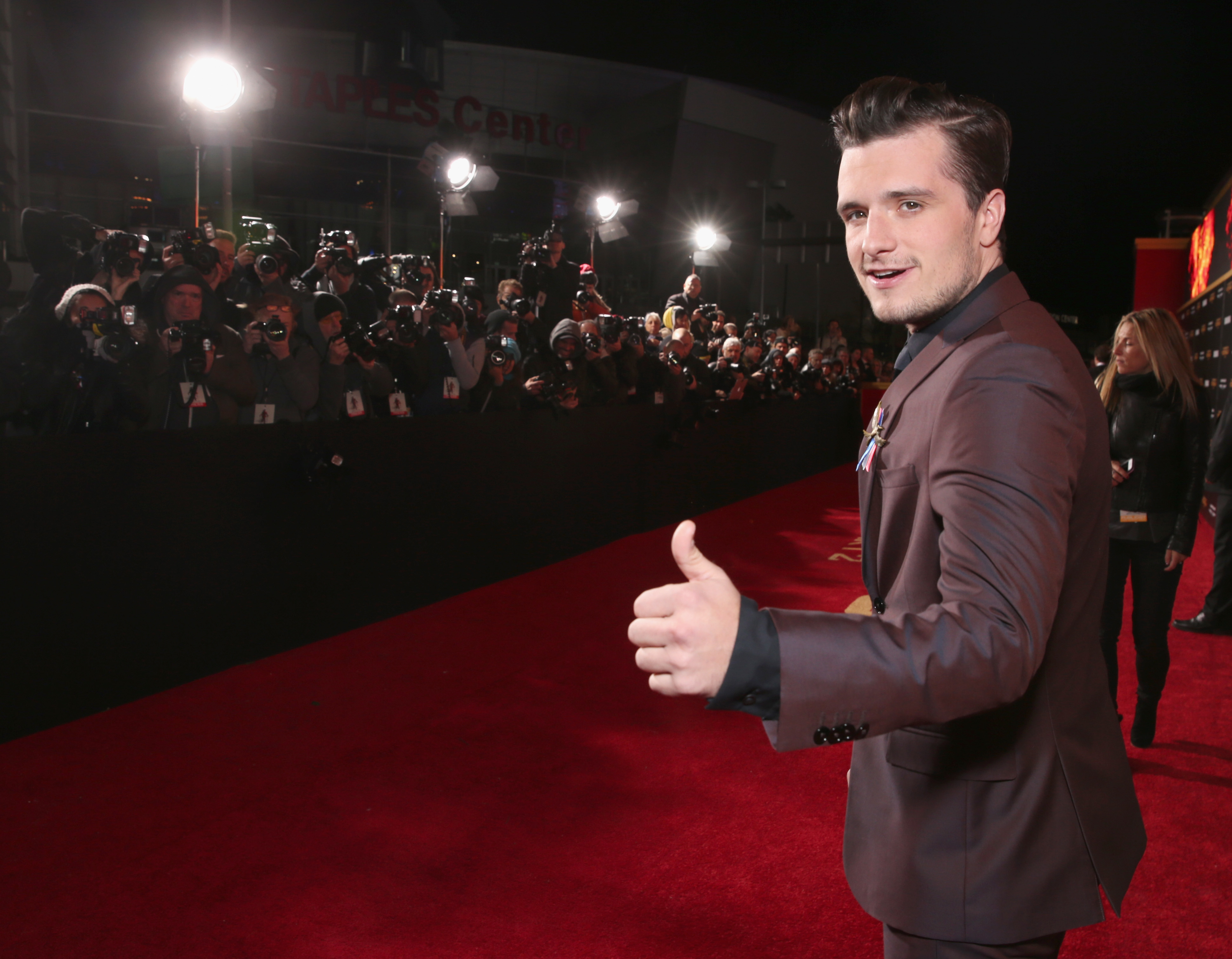 Closeup of Josh Hutcherson giving a thumbs up while on the red carpet