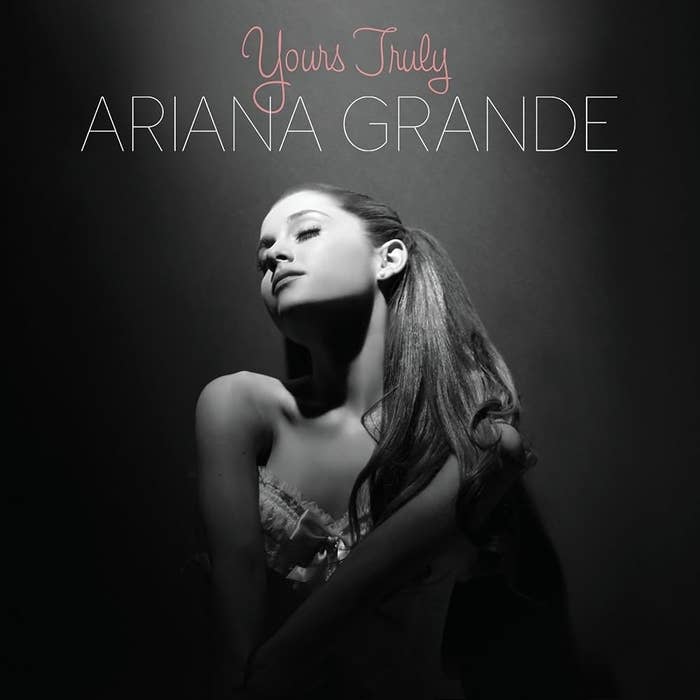 Ariana Grande posing in a strapless top with the title &quot;Yours Truly&quot; above her.