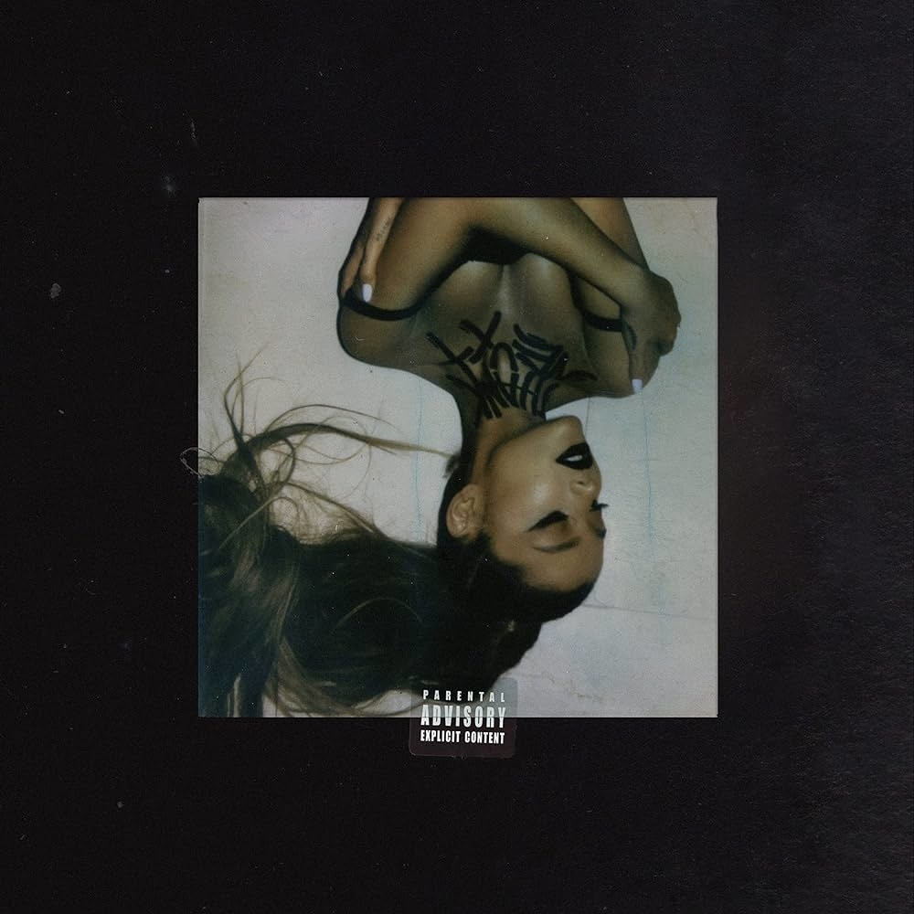 Album cover featuring Ariana Grande with her title upside-down. She wears a black top; the cover has a parental advisory label.
