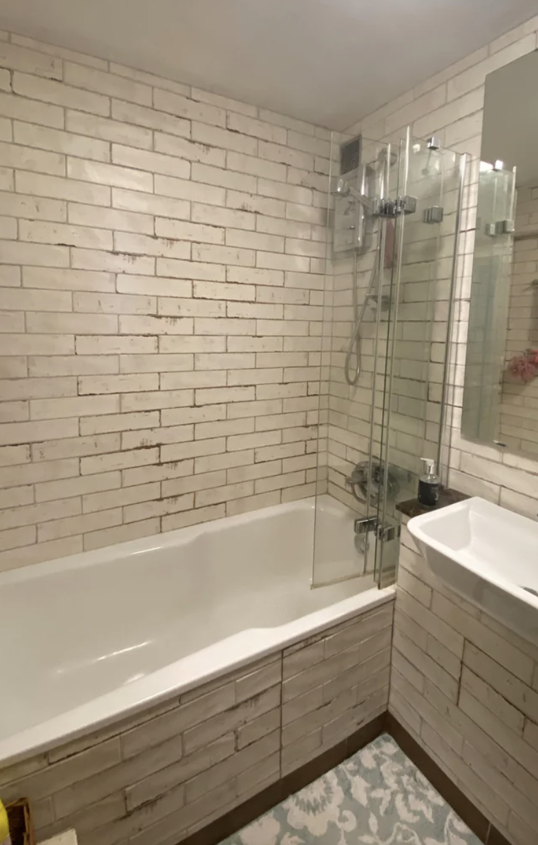An apartment has bathroom tiles designed to look dirty