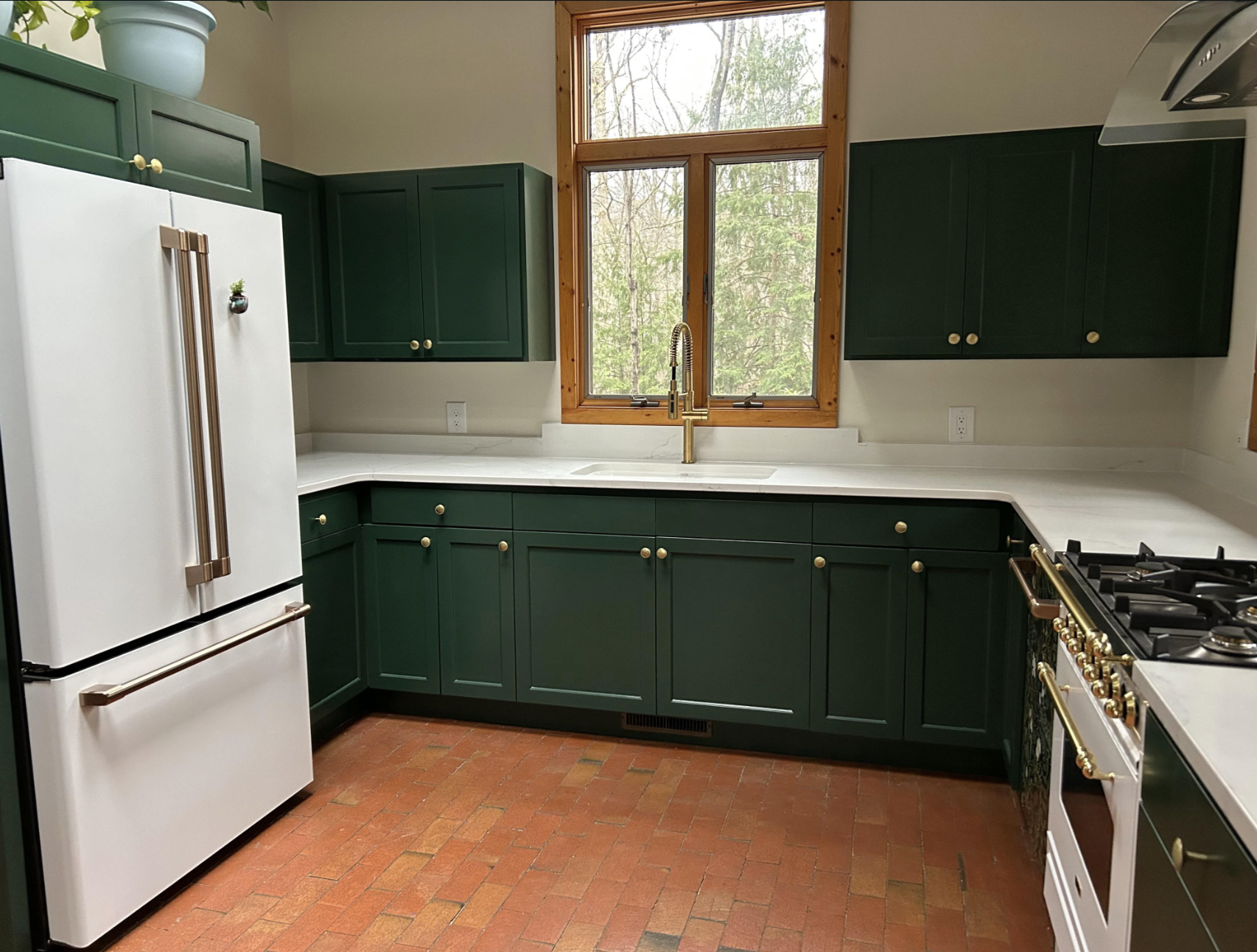 A kitchen has newly painted cabinets