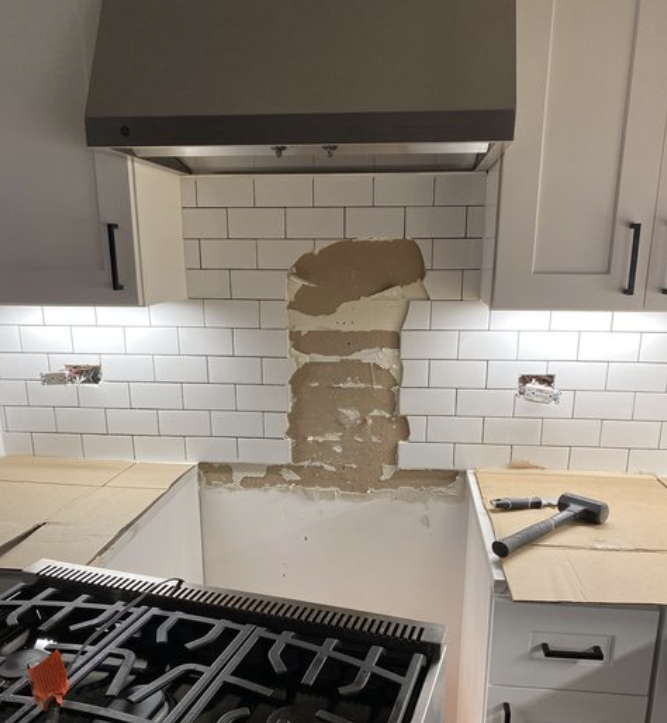 A kitchen backsplash is being replaced