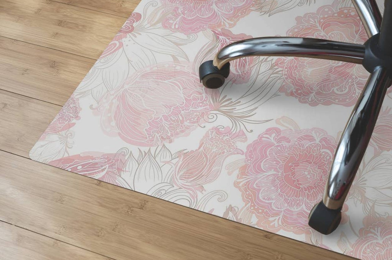 a pink floral printed office chair mat