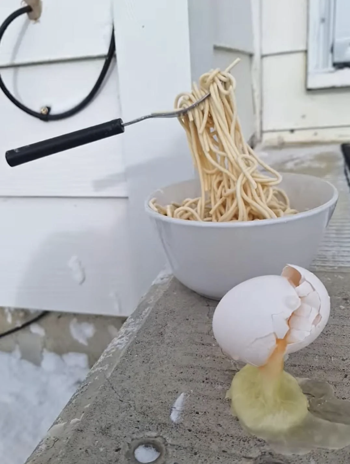 frozen egg and noodles in midair
