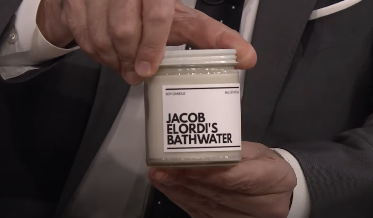 A close-up of Jimmy Fallon holding the candle
