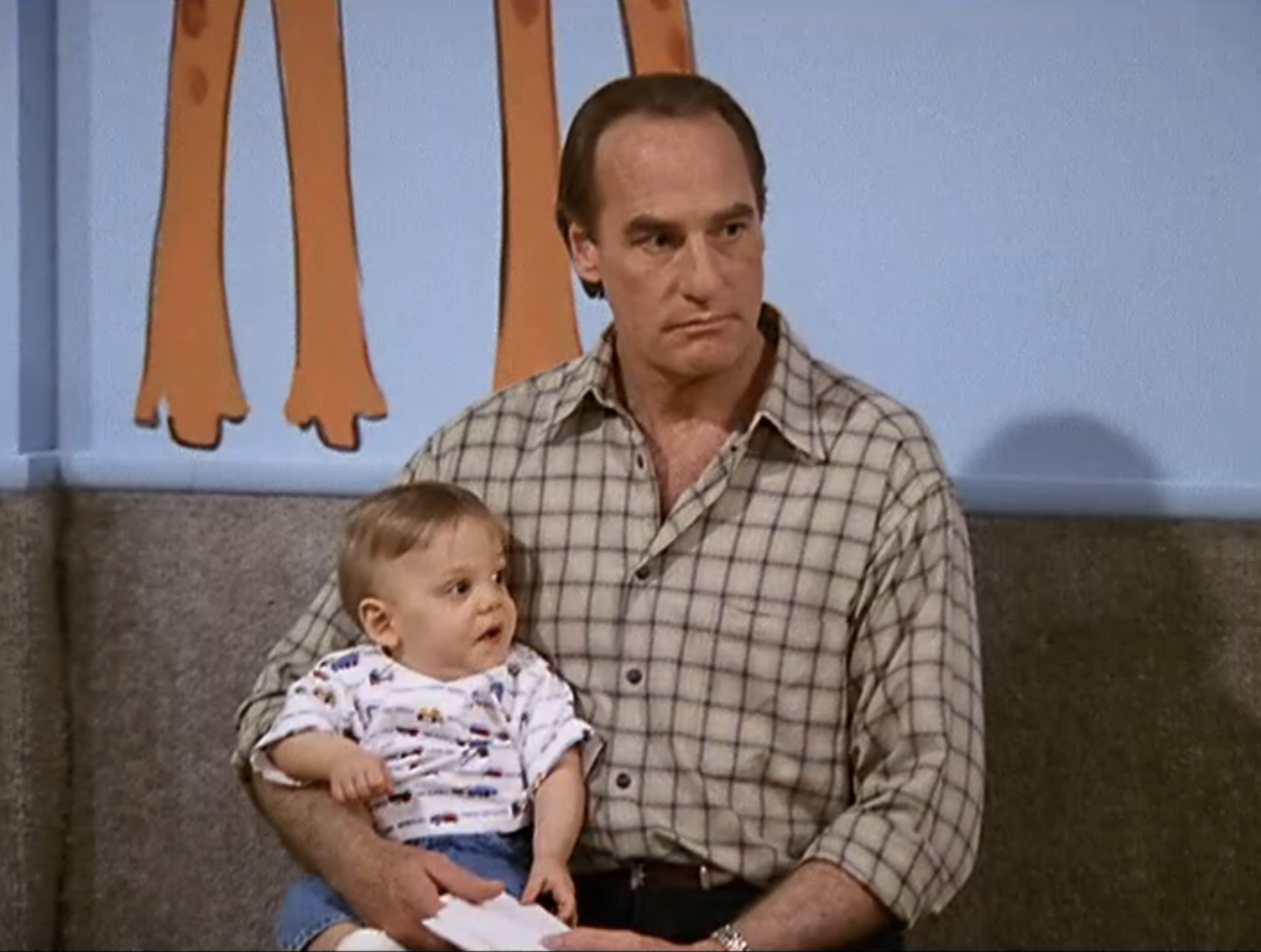 closeup of Craig T. Nelson holding a baby