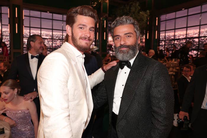 Andrew Garfield and Oscar Isaac being photographed at an event