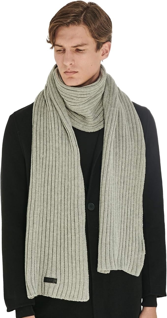 model wearing thick gray cable scarf