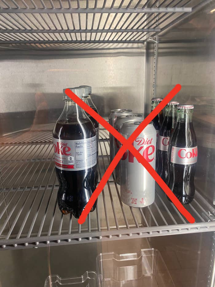 Bottles and cans of Diet Coke in a fridge with an &quot;x&quot; through them