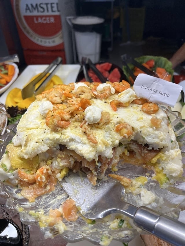 large clump of food halfway eaten with shrimp on top