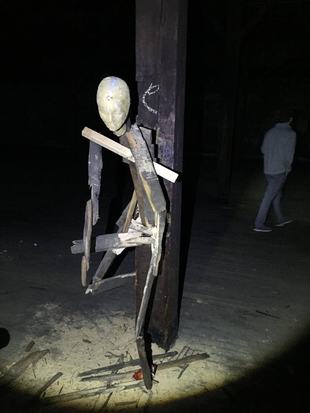 a stick man attached to a pole