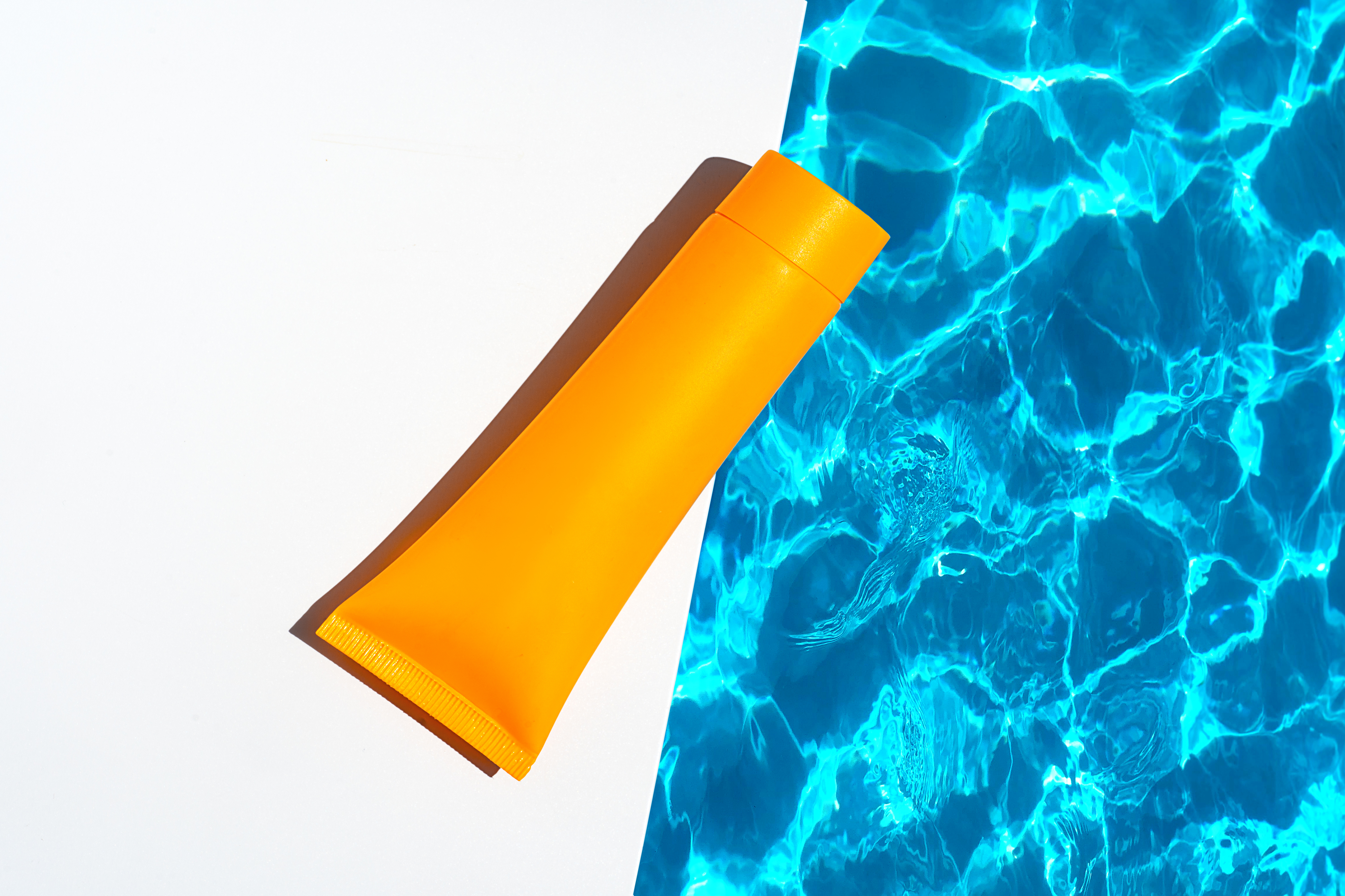 tube of sunscreen by a pool