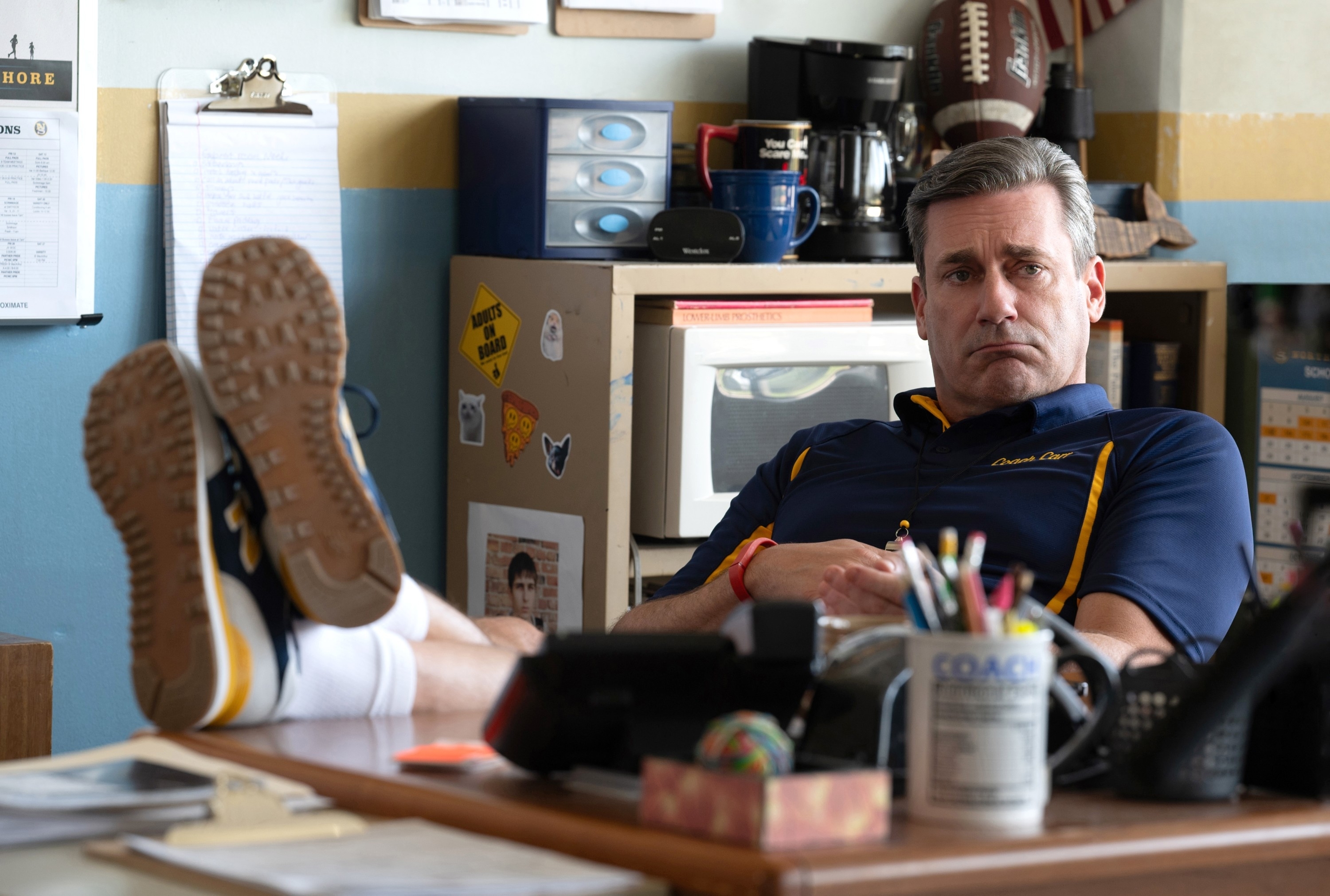 coach carr with his feet on his desk