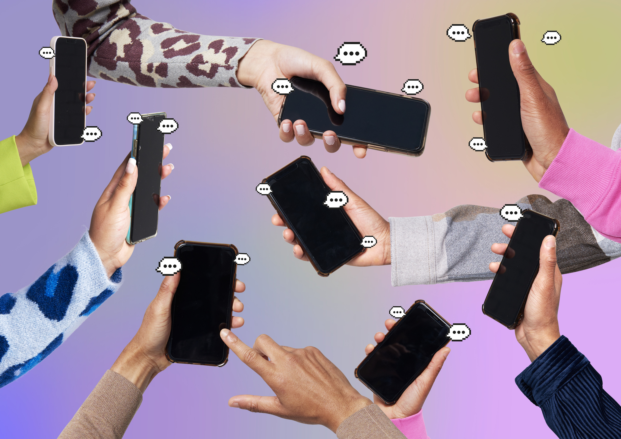 Many hands holding cellphones with &quot;chat bubbles&quot; around each phone