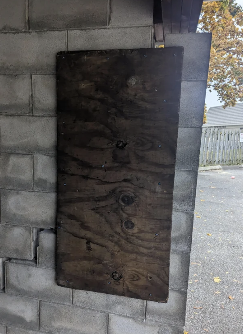 the back of the wall with a thin piece of wood trying to hold the crack together