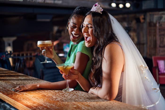a bride-to-be with her friend at a bar for her bachelorette party
