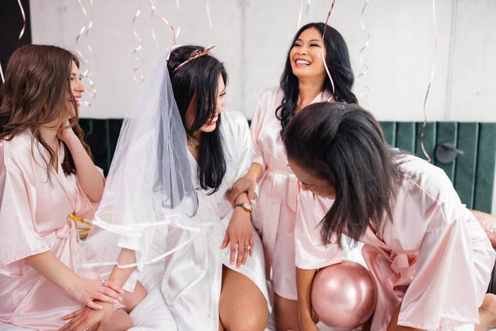 a bride-to-be laughing with her bridal party