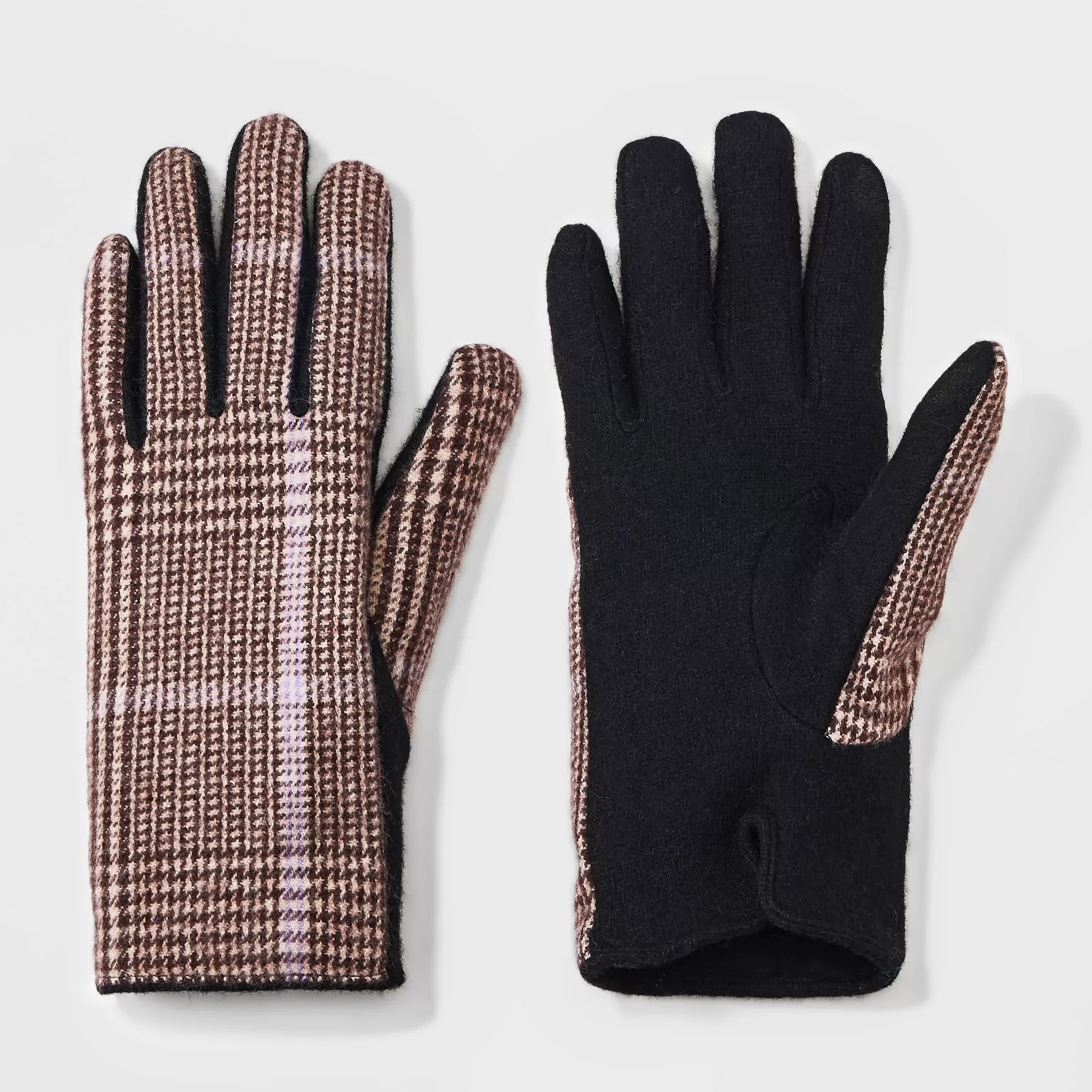 The gloves, which have a pink plaid design on one side and plain black on the other