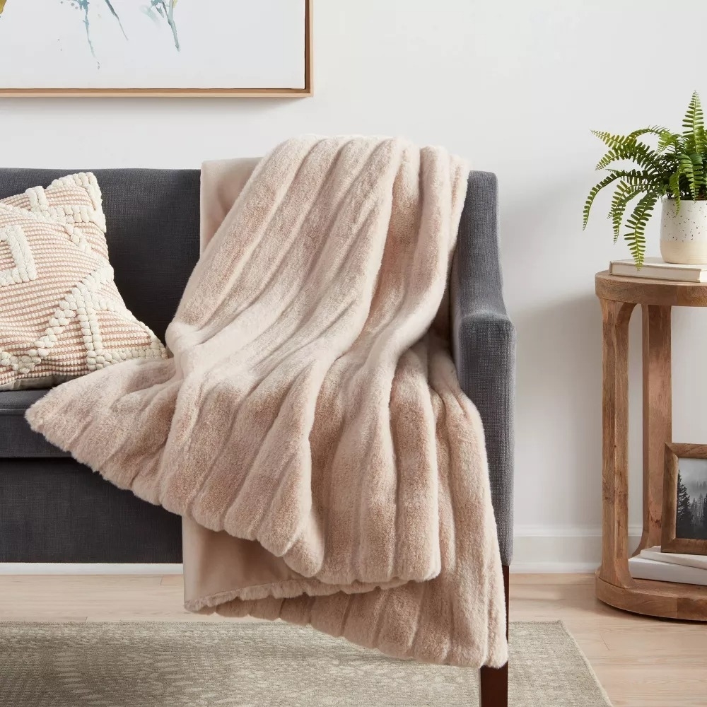the textured faux fur throw on a couch