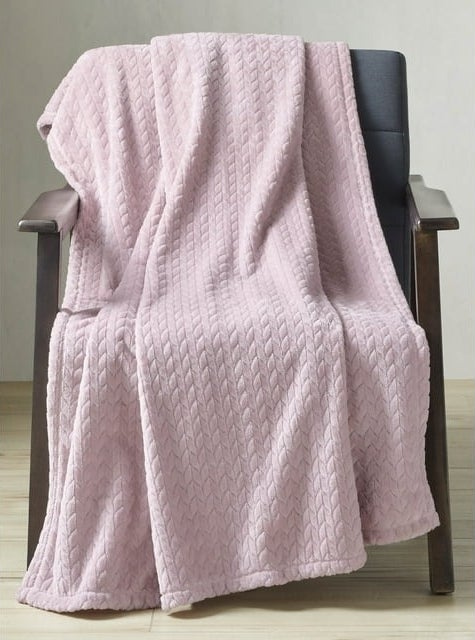 large pink plush throw blanket on a chair