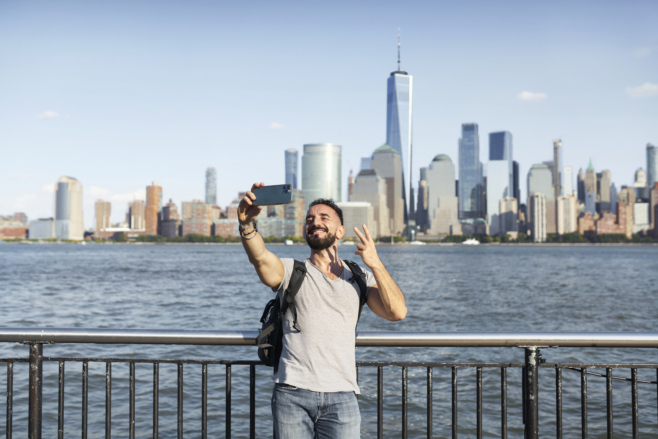 person taking a selfie with a city behind them