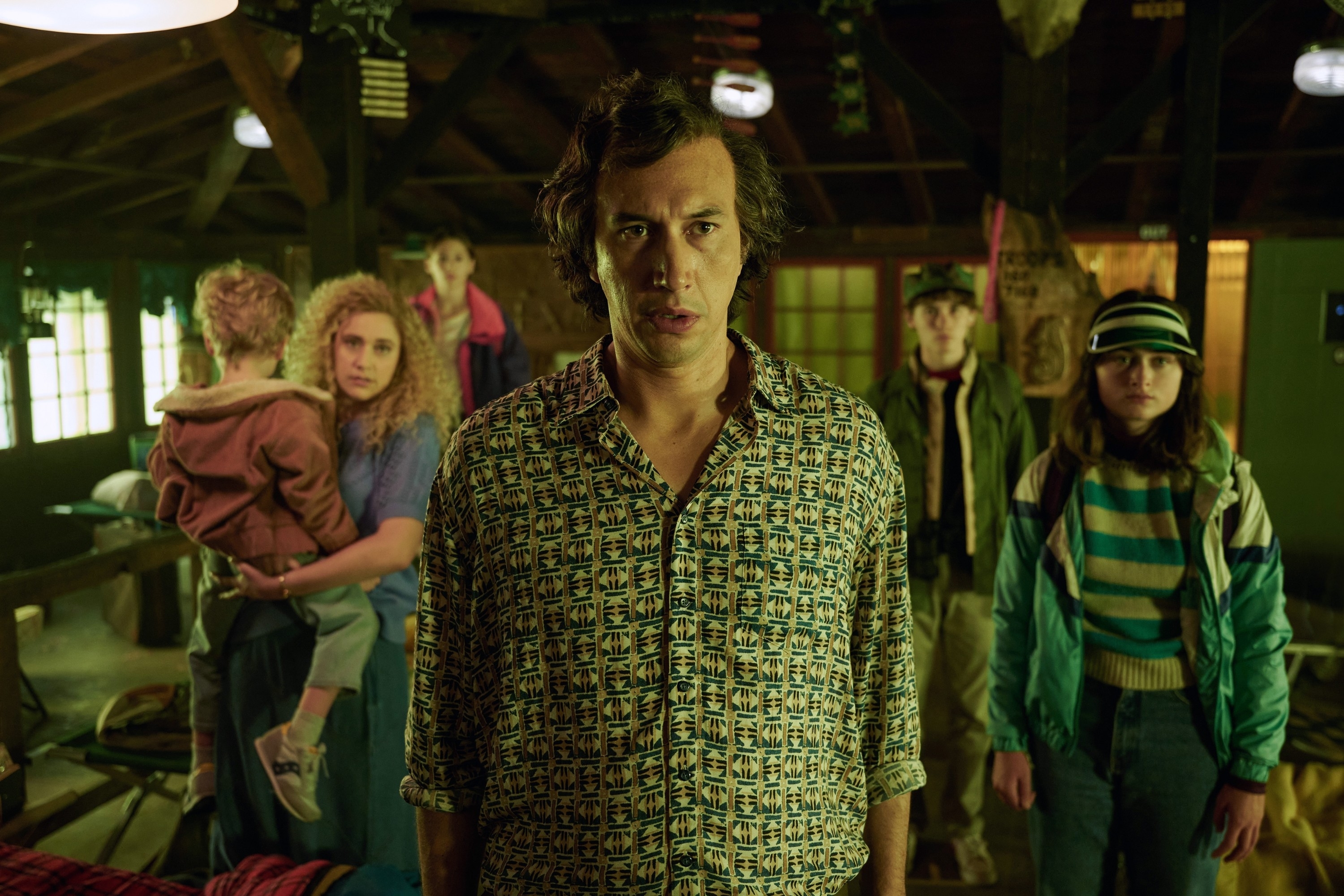 him and a family behind him in the film